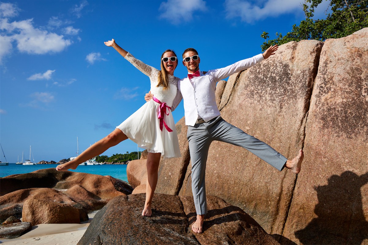 A romantic wedding moment captured in the Seychelles Islands, featuring a couple against a backdrop of stunning tropical scenery.